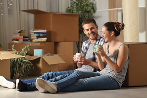 Happy couple taking a break during their move